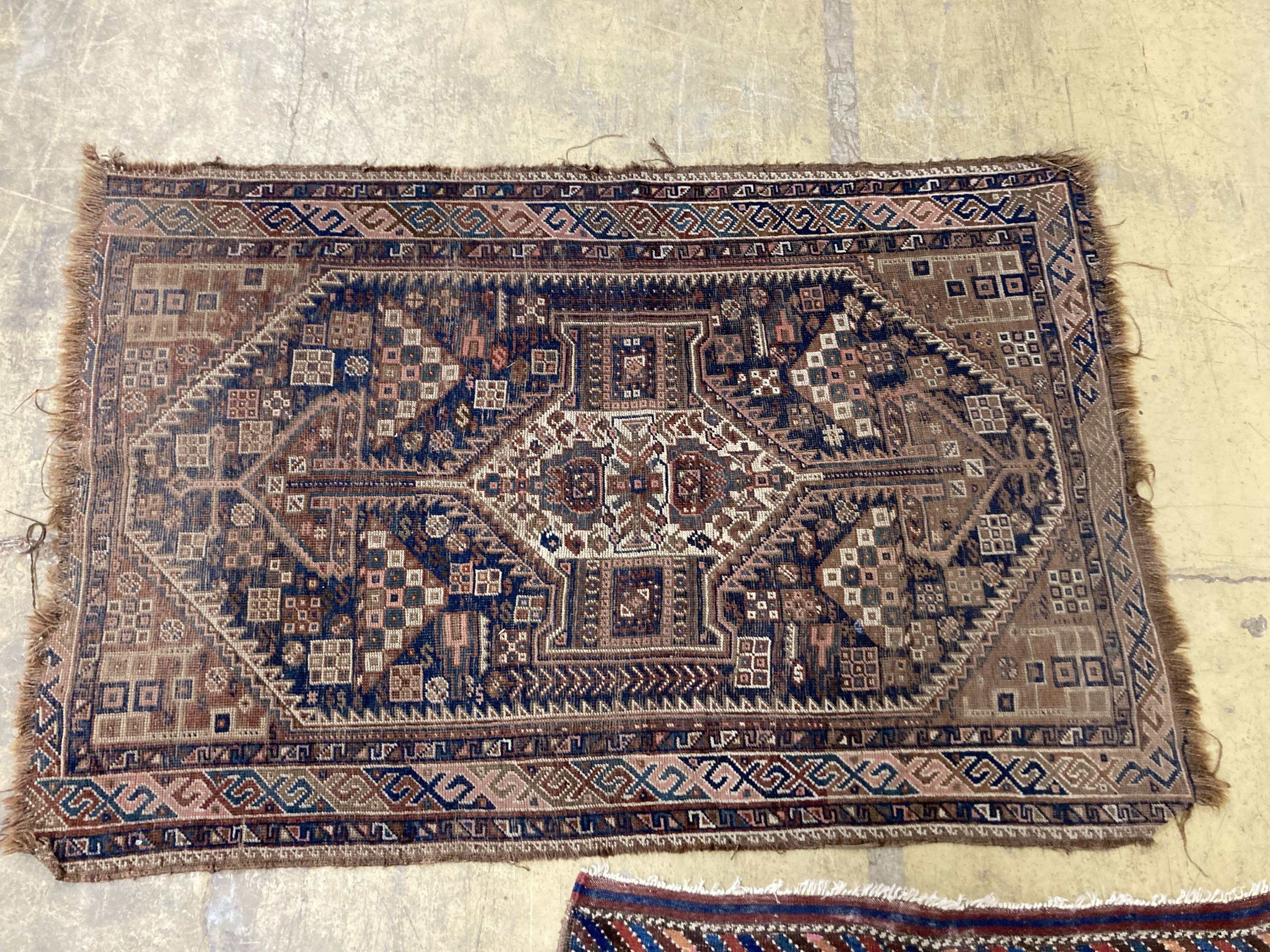 Three antique Caucasian blue ground rugs, largest 154 x 114 cms.